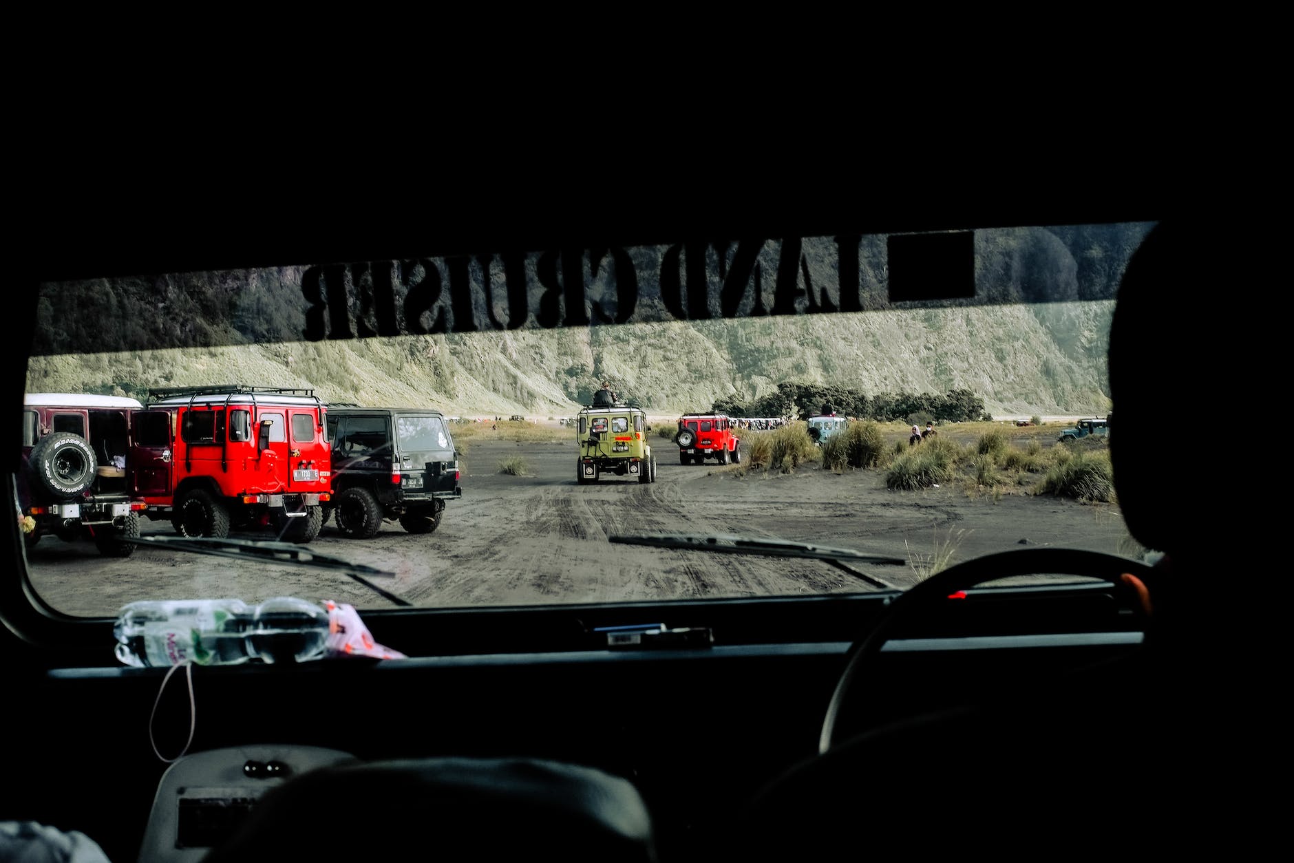 driving a dirt road among off road vehicles